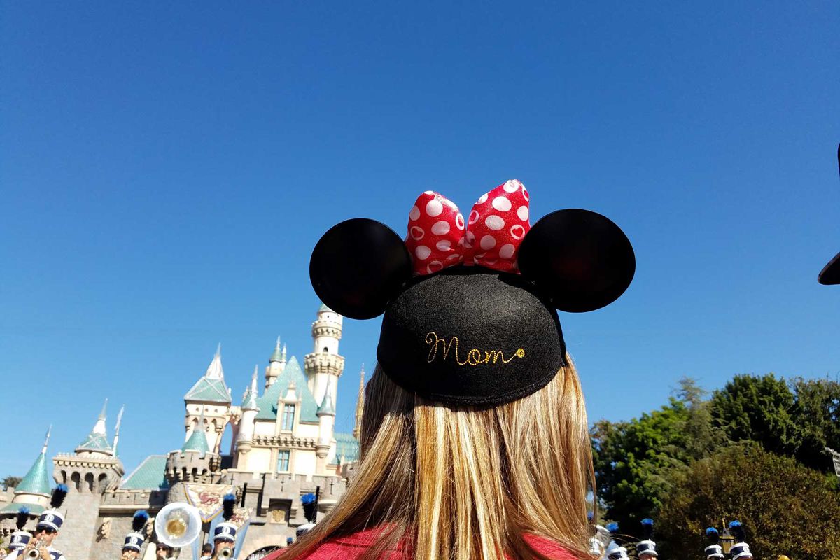 Walt Disney World Magic Kingdom guest wearing Mickey Mouse ears with Mom written on the back