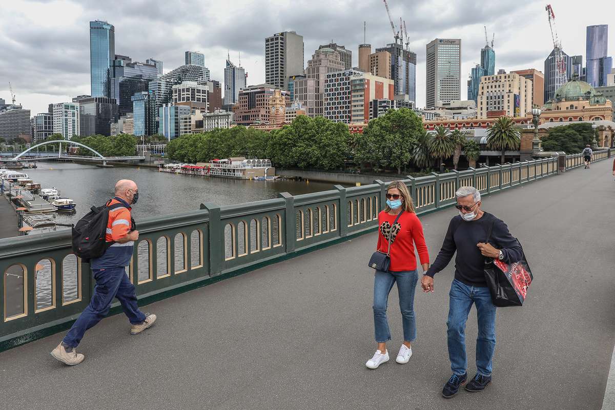 A general view of pedestrians crossing the bridge with the Yarra River in Melbourne, Australia.