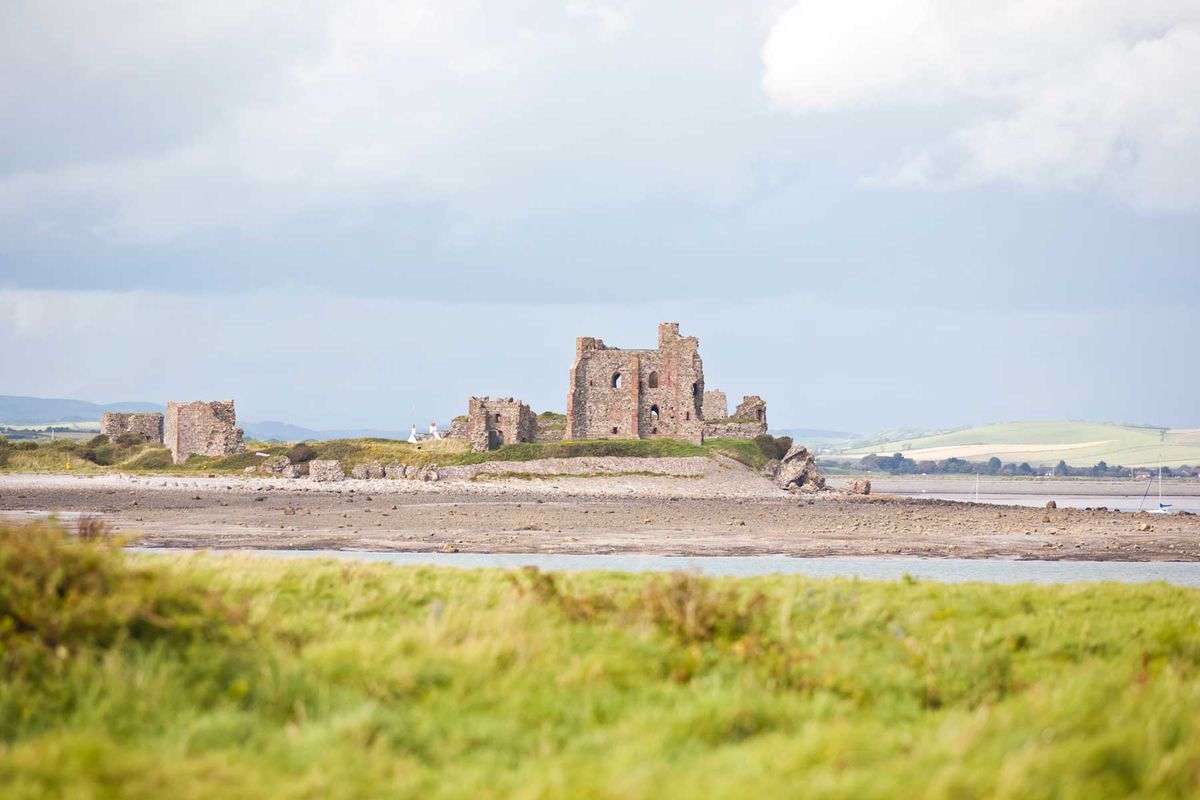A view of Piel castle form Walney Island near Barrow in Furness at low tide