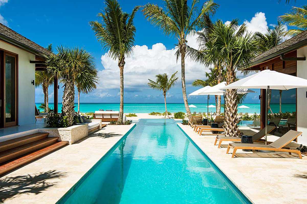Edge Retreats Hawksbill villas in Turks and Caicos, luxury spaces with beautiful ocean views and palm trees