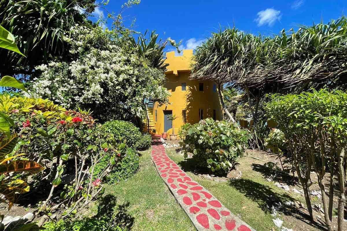Azzurra Castle in Grenada, Caribbean styling, brightly colored rental space in a castle structure with a pool