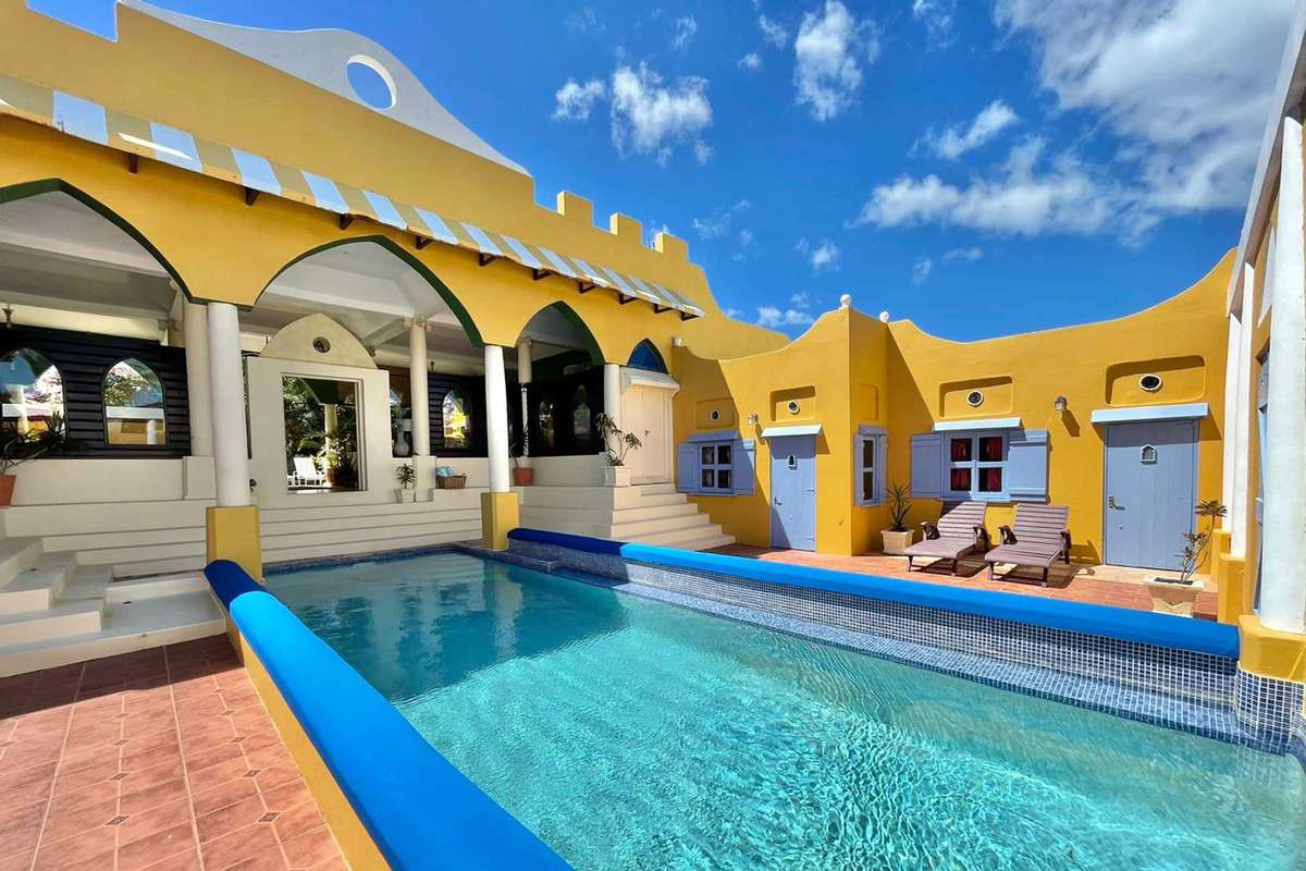 Azzurra Castle in Grenada, Caribbean styling, brightly colored rental space in a castle structure with a pool