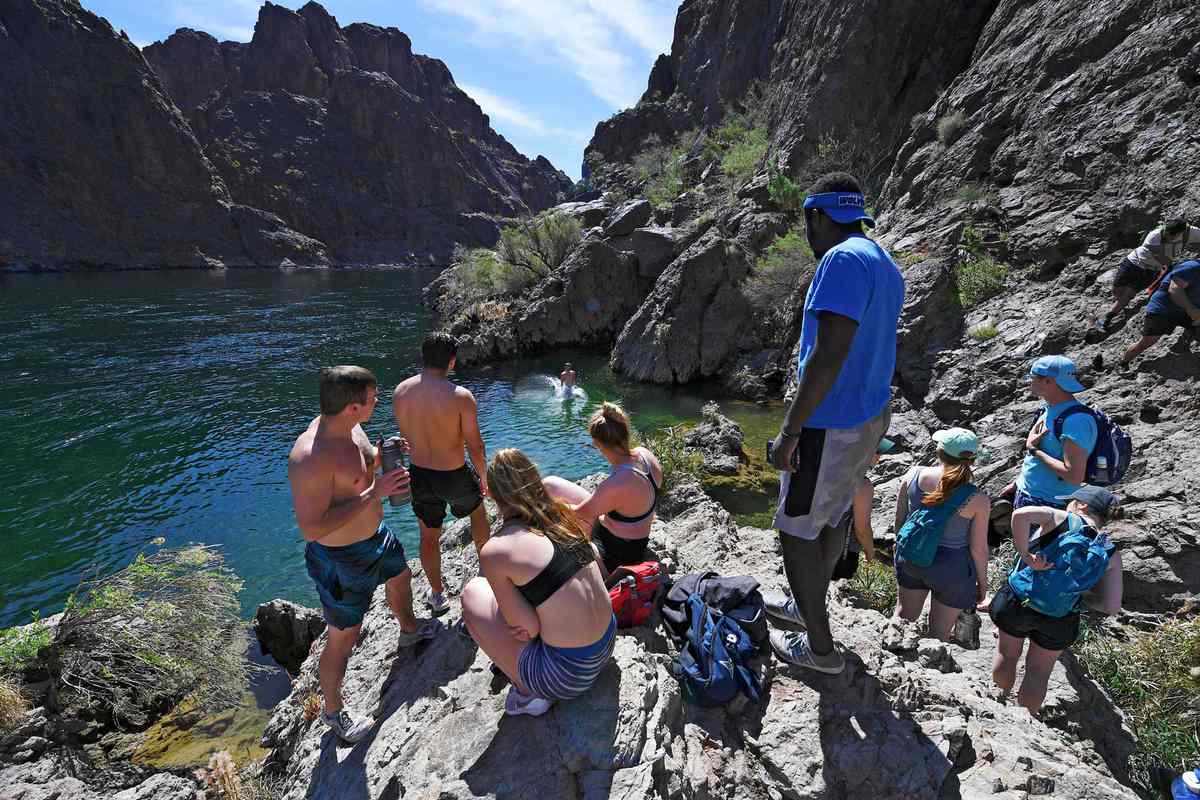A hiker jumps into the Colorado River at the terminus of the Gold Strike Hot Springs trail Saturday, April 5, 2019