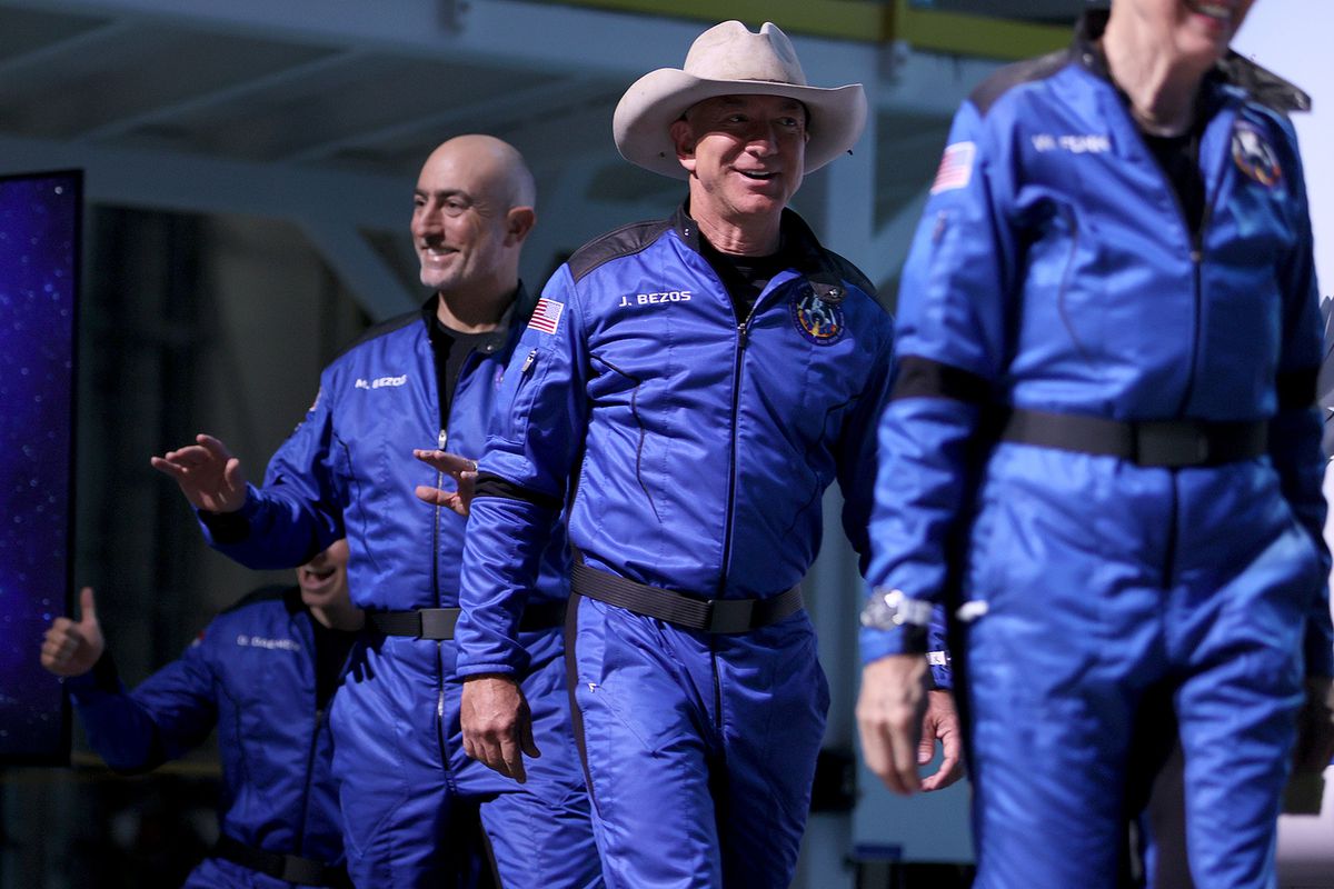 Blue Origin’s New Shepard crew (L-R) Oliver Daemen (hidden), Mark Bezos, Jeff Bezos, and Wally Funk arrive for a press conference after flying into space in the Blue Origin New Shepard