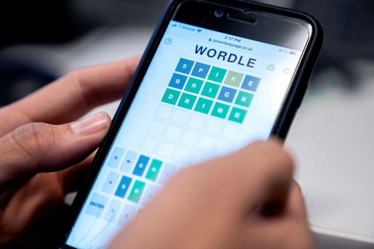 This photo illustration shows a person playing online word game "Wordle" on a mobile phone in Washington, DC on January 11, 2022