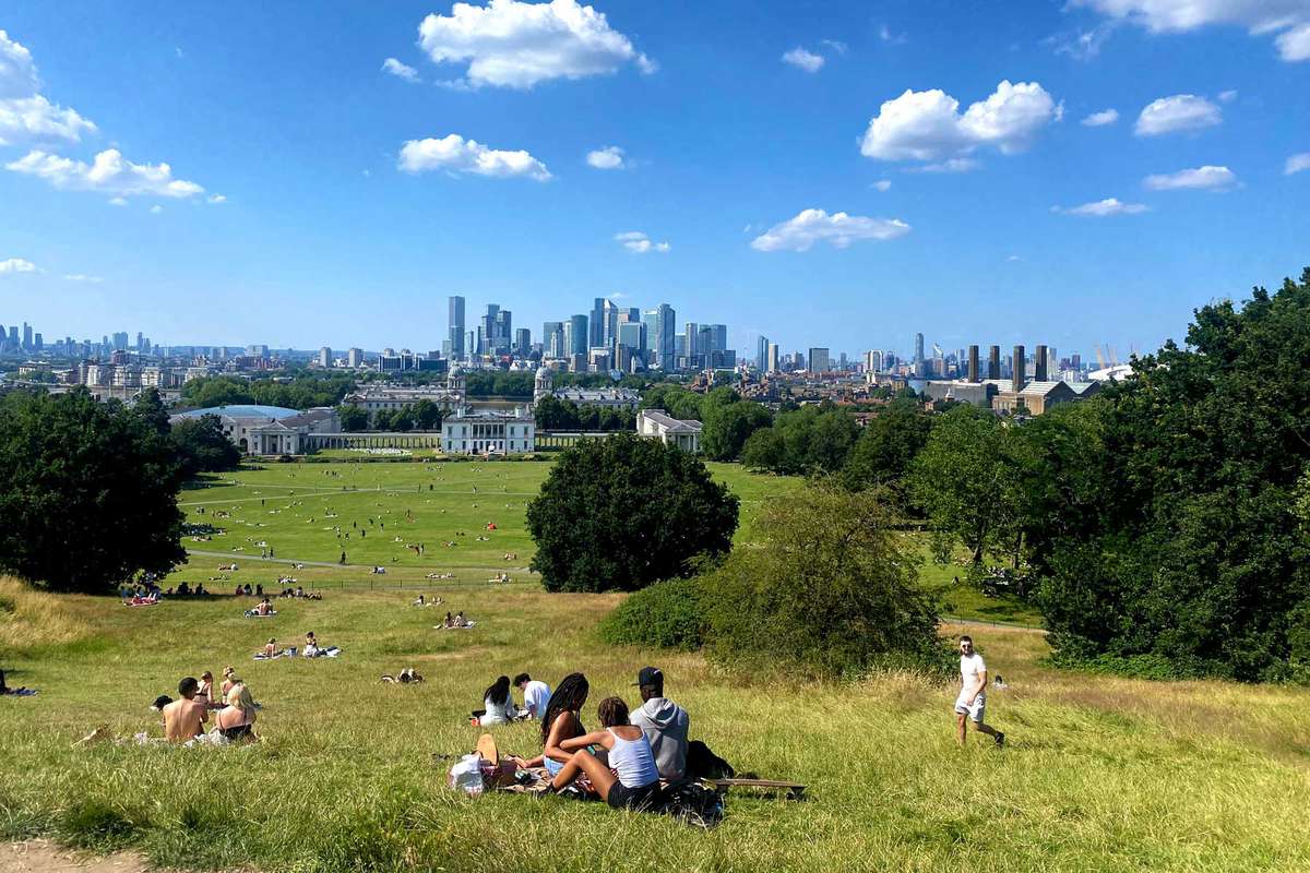 Landscape view of people enjoying a sunny day in Greenwich Park in London