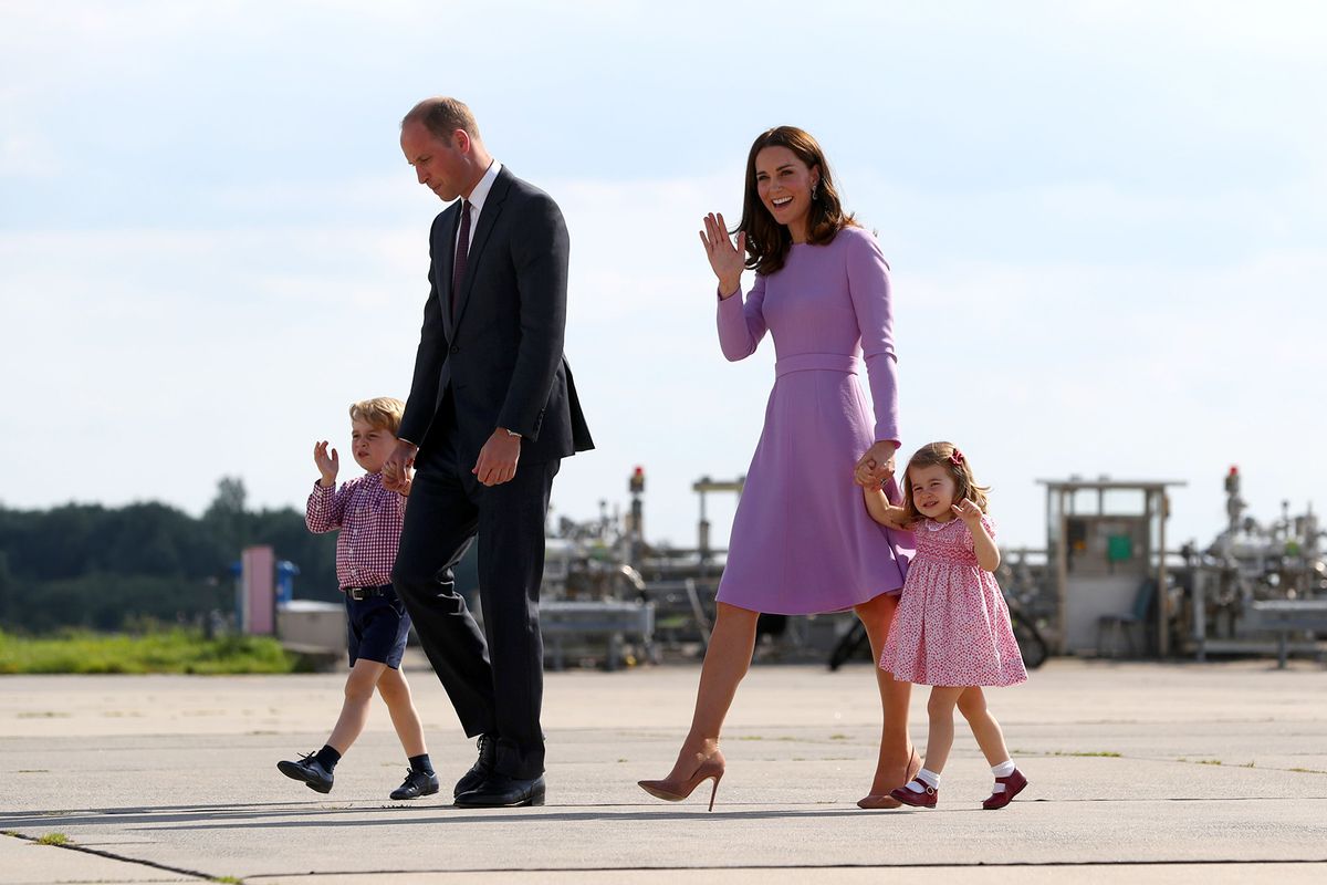 Prince William, Duke of Cambridge, Kate, the Duchess of Cambridge, and their children Prince George and Princess Charlotte walk on the tarmac in Hamburg