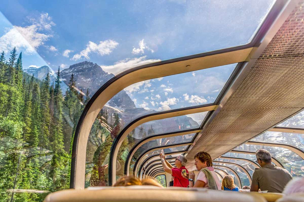Mountaineer train traveling through the Rocky Mountains with luxury dining on board.