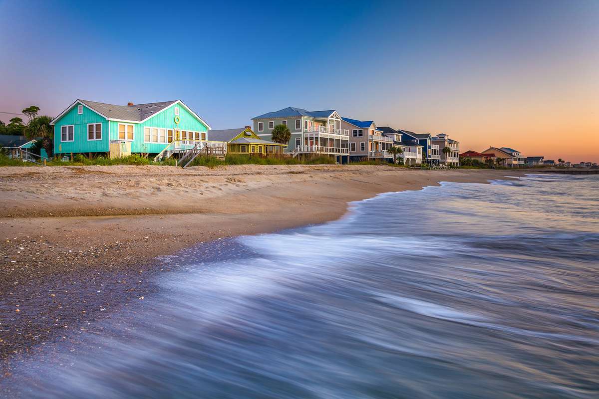 Waves in the Atlantic Ocean and beachfront homes at sunrise, Edisto Beach, South Carolina
