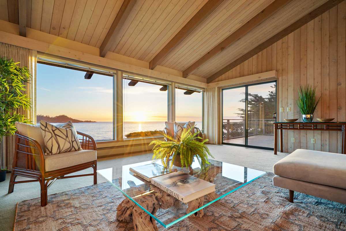 Interiors and exteriors of Betty White's Carmel, California home that is pristine and on the coastline with expansive views of the ocean. The home is mid-century modern.
