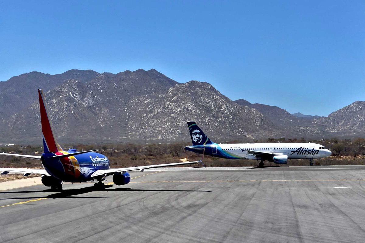 Alaska airlines (R) and Southwest airlines aircrafts wait at the runway for takeoff at the San Jose del Cabo International Airport (SJD) in Baja California state, Mexico, on April 29, 2021.