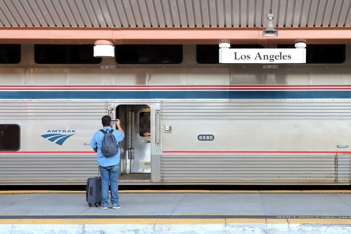 Passenger taking photos and waiting to board an Amtrak train, Los Angeles Union Station.