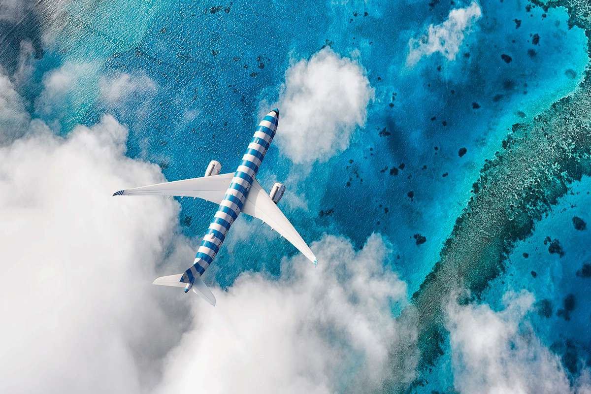 A new Condor plane in Sea blue flying over the Maldives