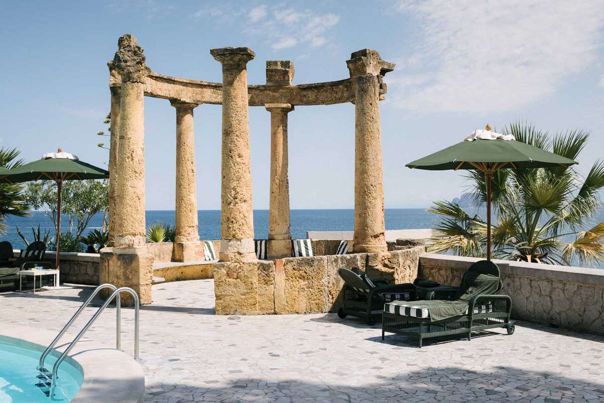 Pool terrace of the Villa Igiea hotel in Sicily, with ancient ruins