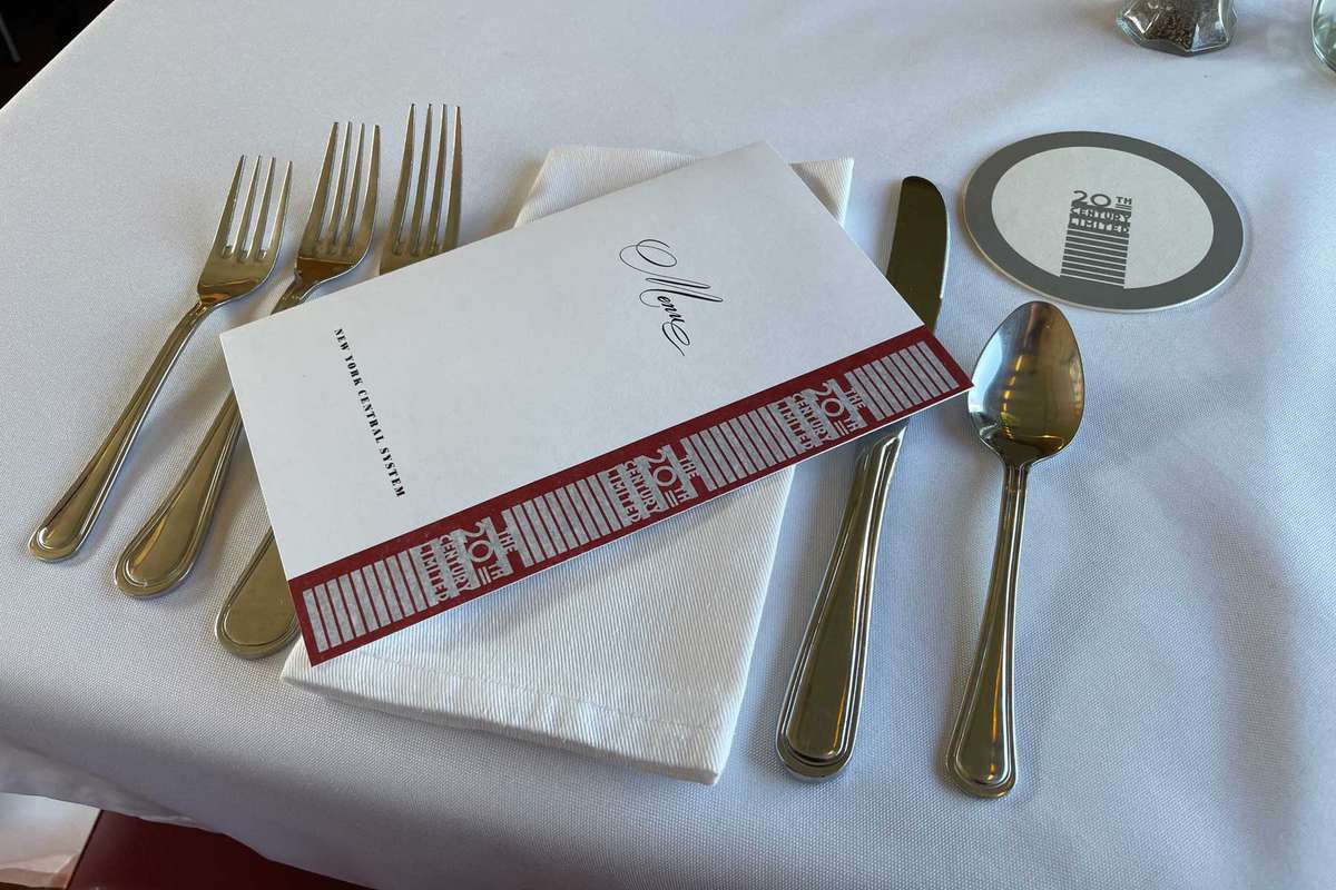 A dining car menu and setting for 20th Century Limited train