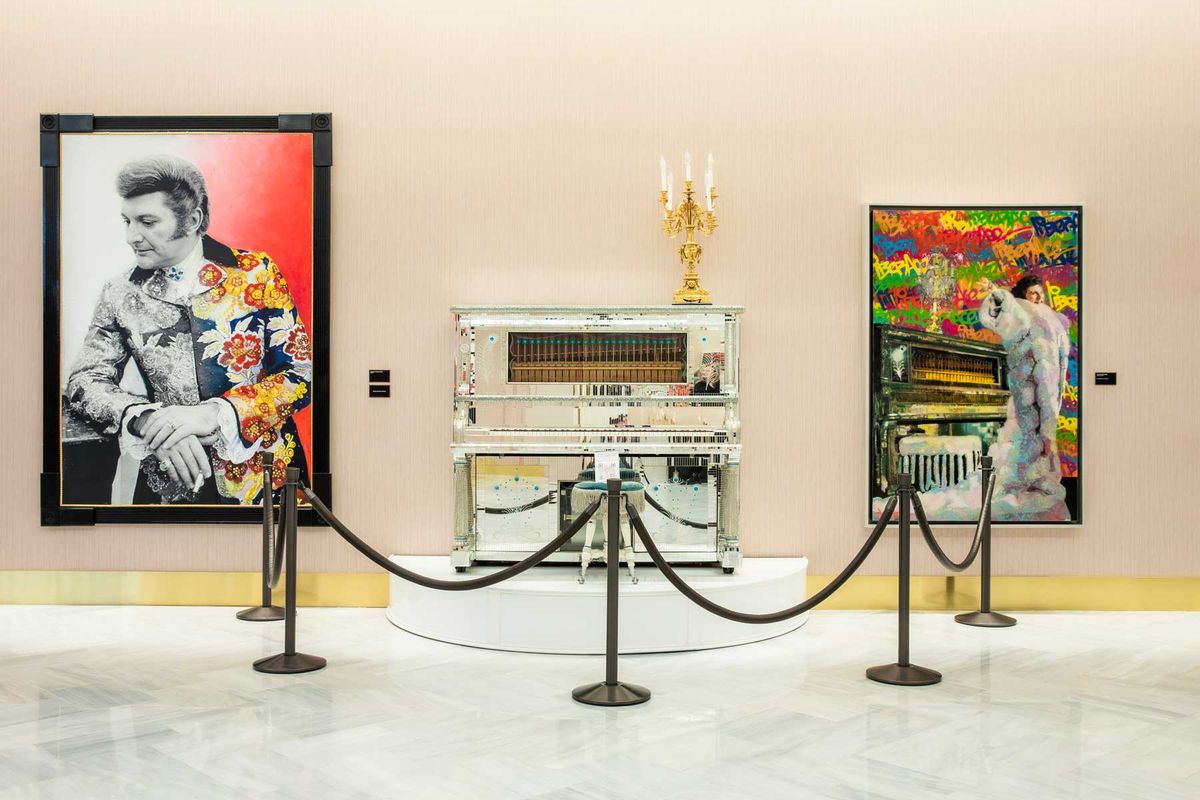 A piano, candelabra, and artwork from Liberace's collection, on display at Resorts World