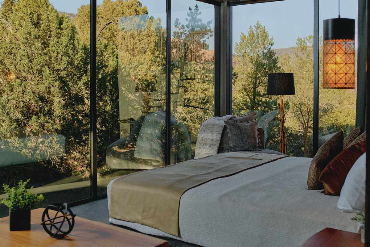 A glass-walled guest bedroom at the Ambiente Landscape Hotel in Sedona, Arizona