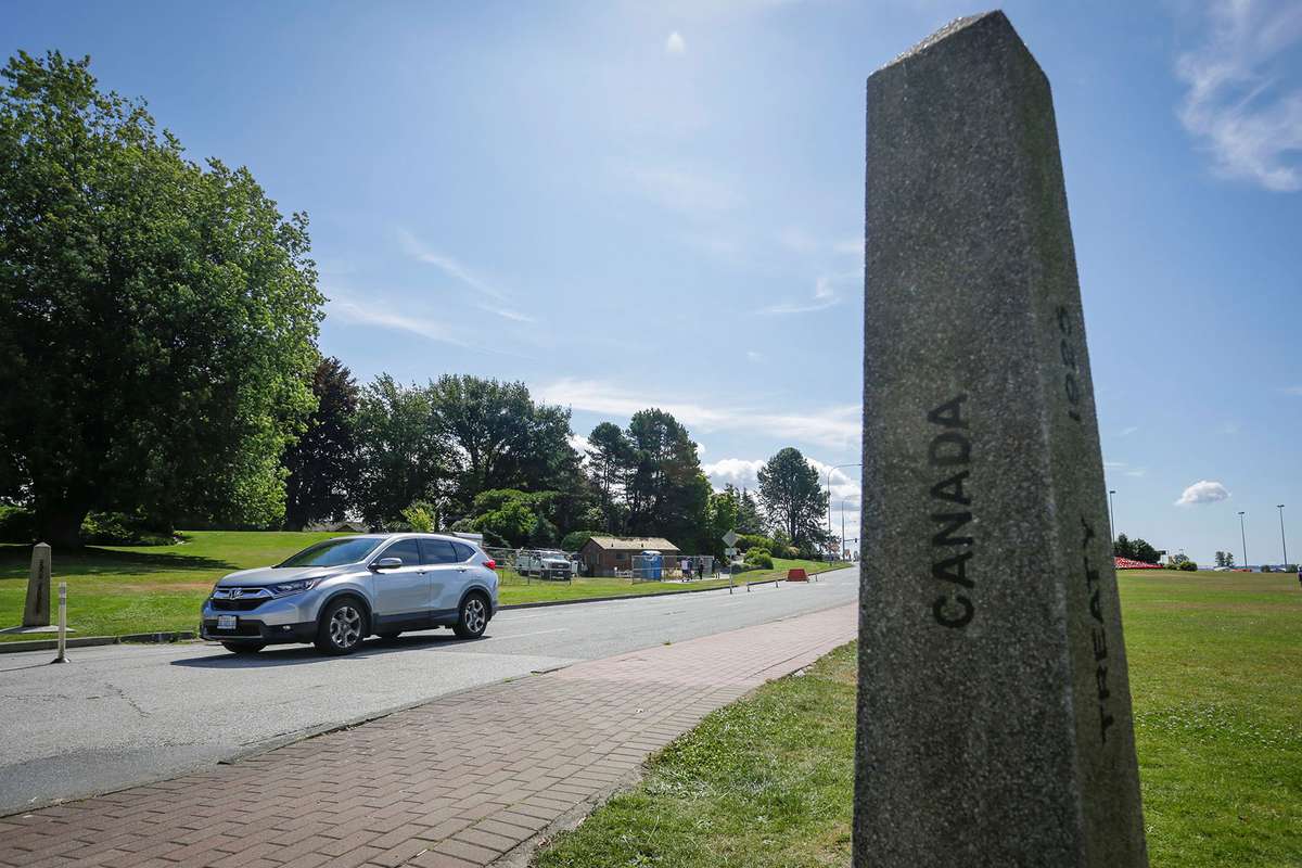 A vehicle from the United States passes through a boundary marker at the Peace Arch border crossing in Surrey, British Columbia, Canada,