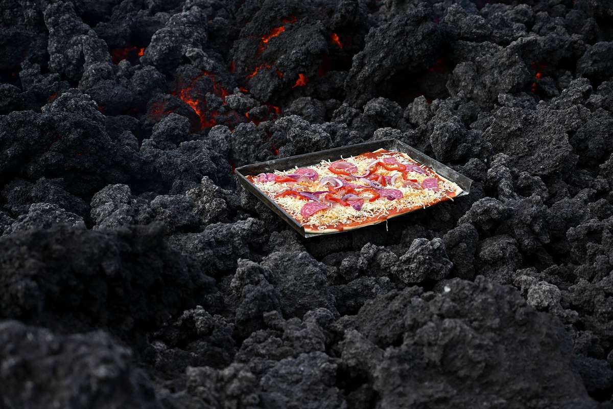 a pizza being cooked on a lava river in Guatemala