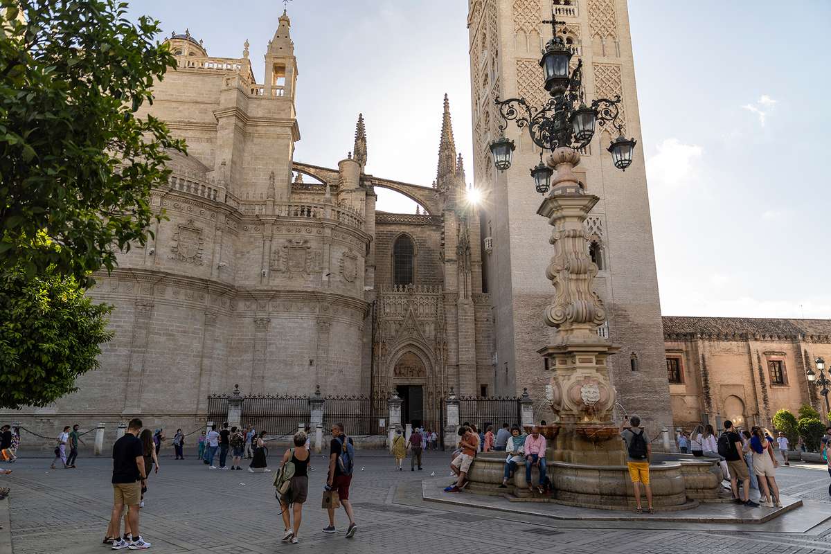 Tourist walk next to the Cathedral of Saint Mary of the See, better known as Seville Cathedral, in Seville, Spain.