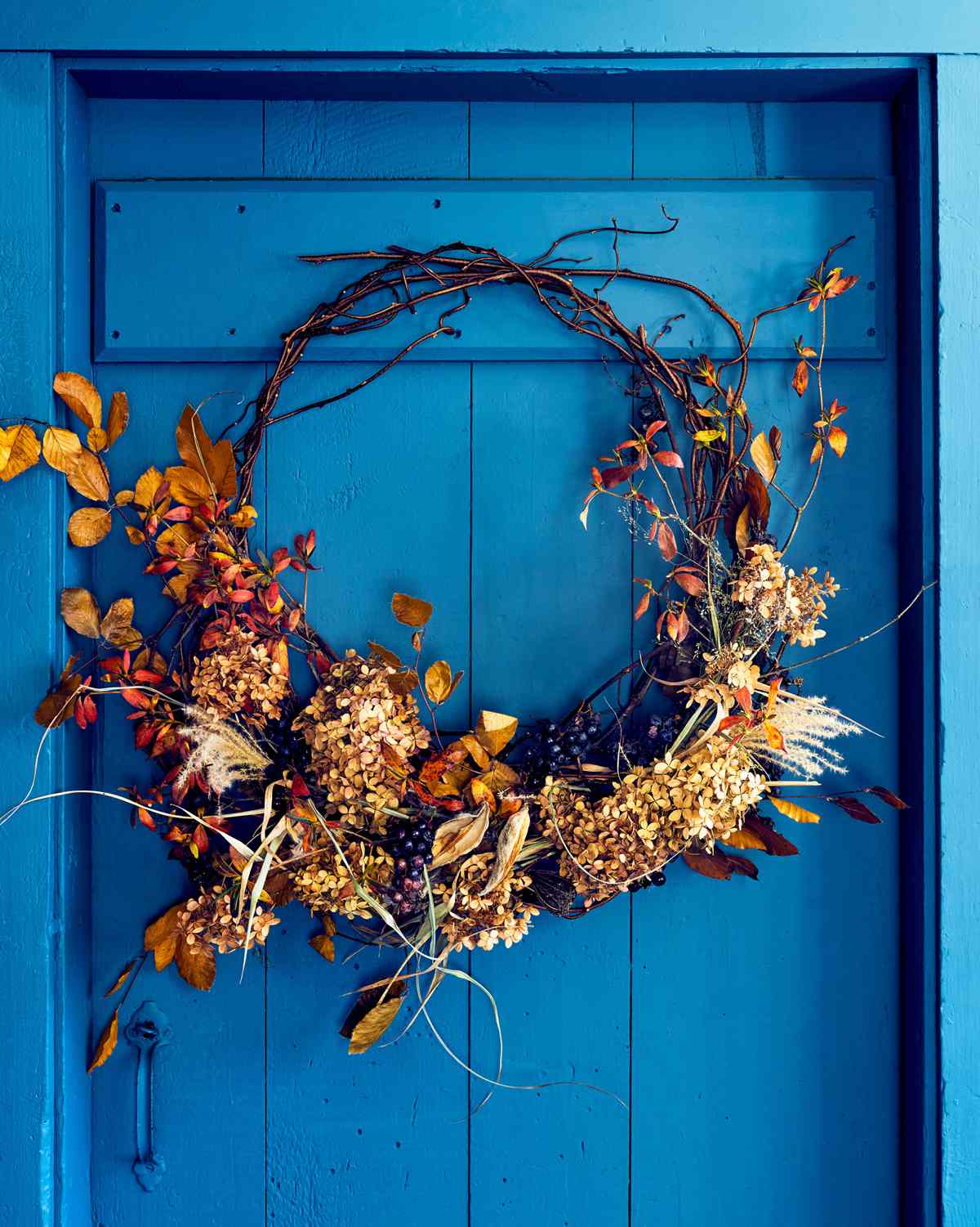wreath hanging on blue door