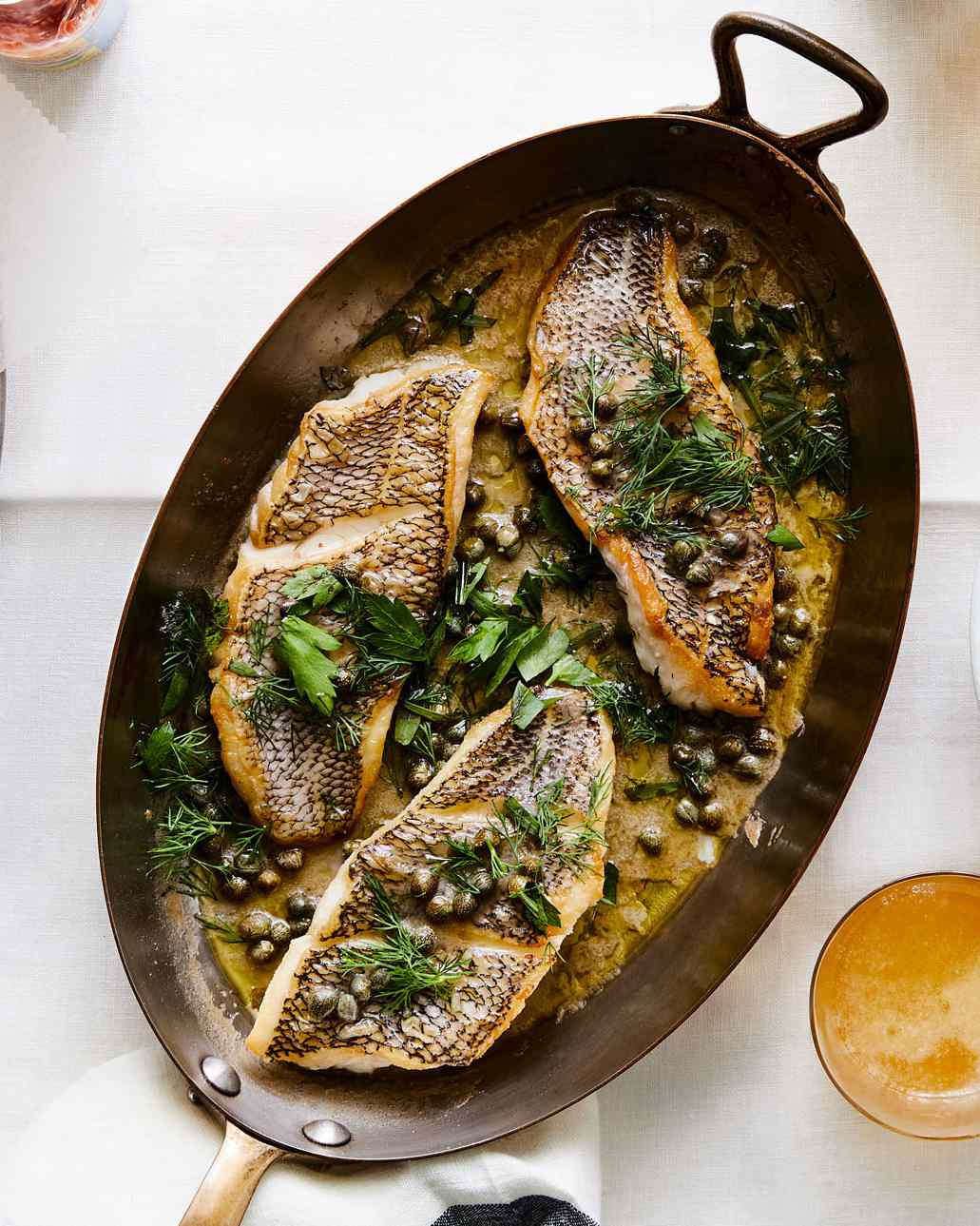 Black Sea Bass with Capers and Herb-Butter Sauce in large pan