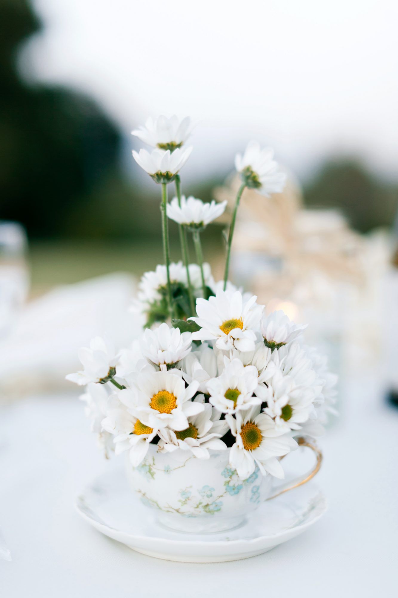 white flowers wedding centerpiece tea cup saucer