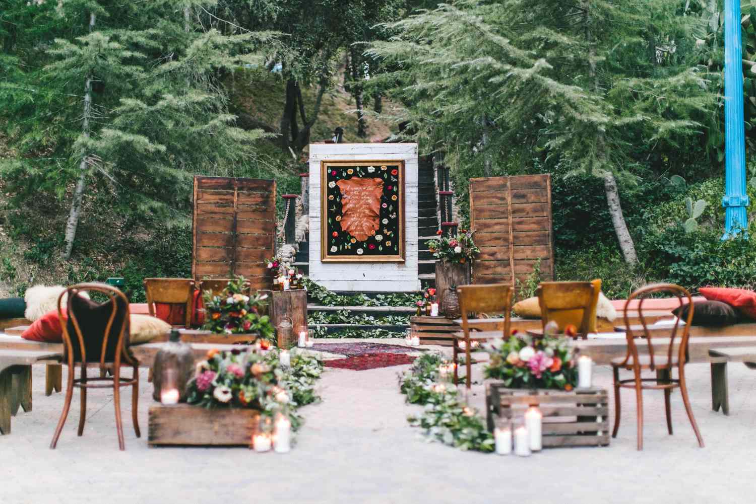mismatched ceremony aisle with pillows and chairs