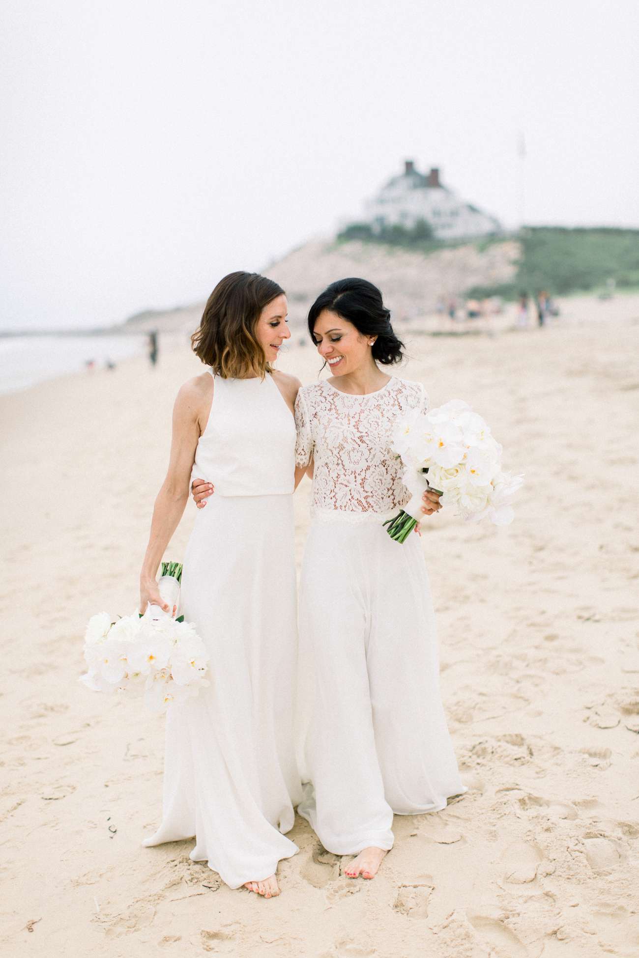 brides walk on ocean front beach