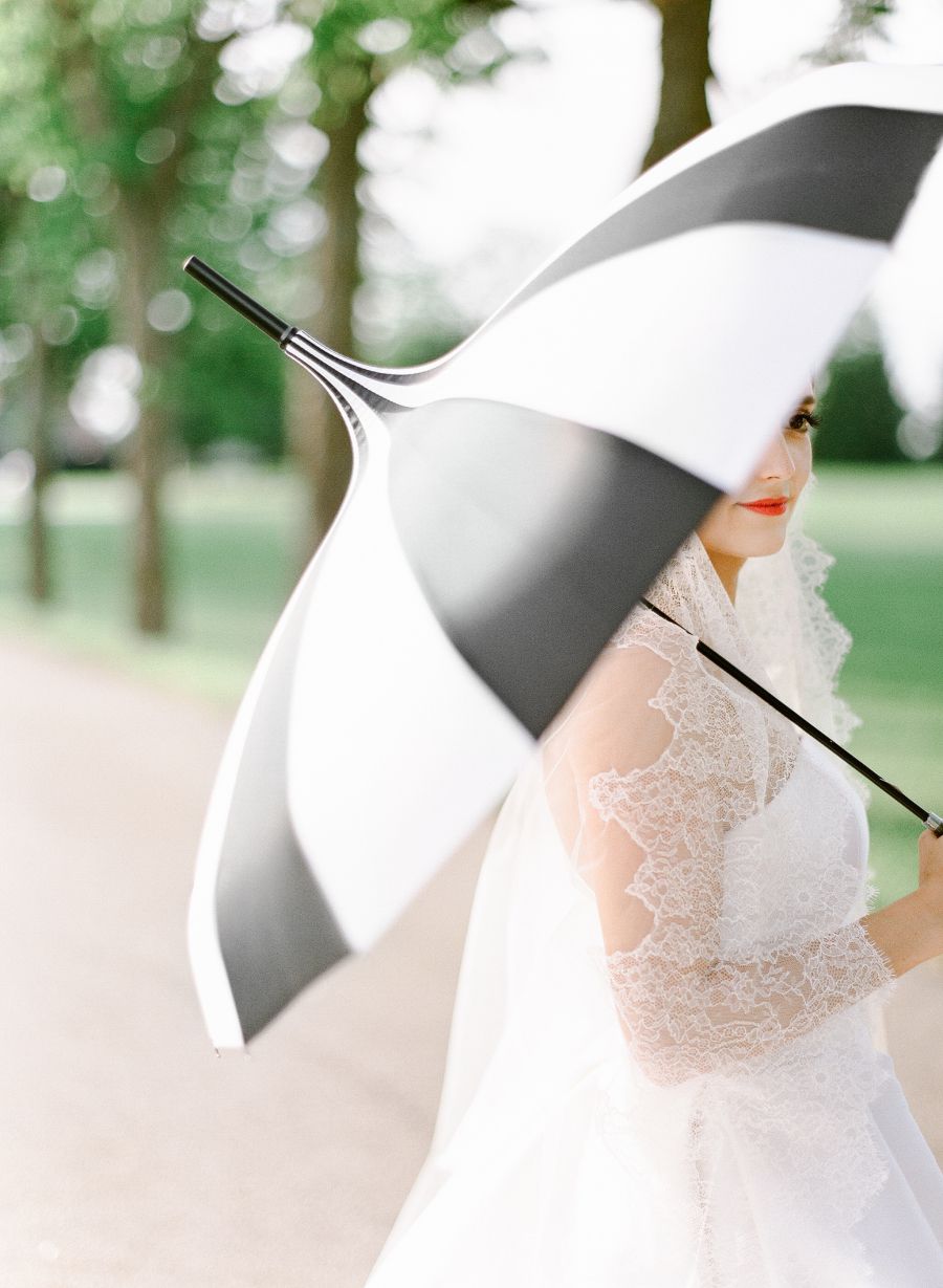 bride holding striped umbrella