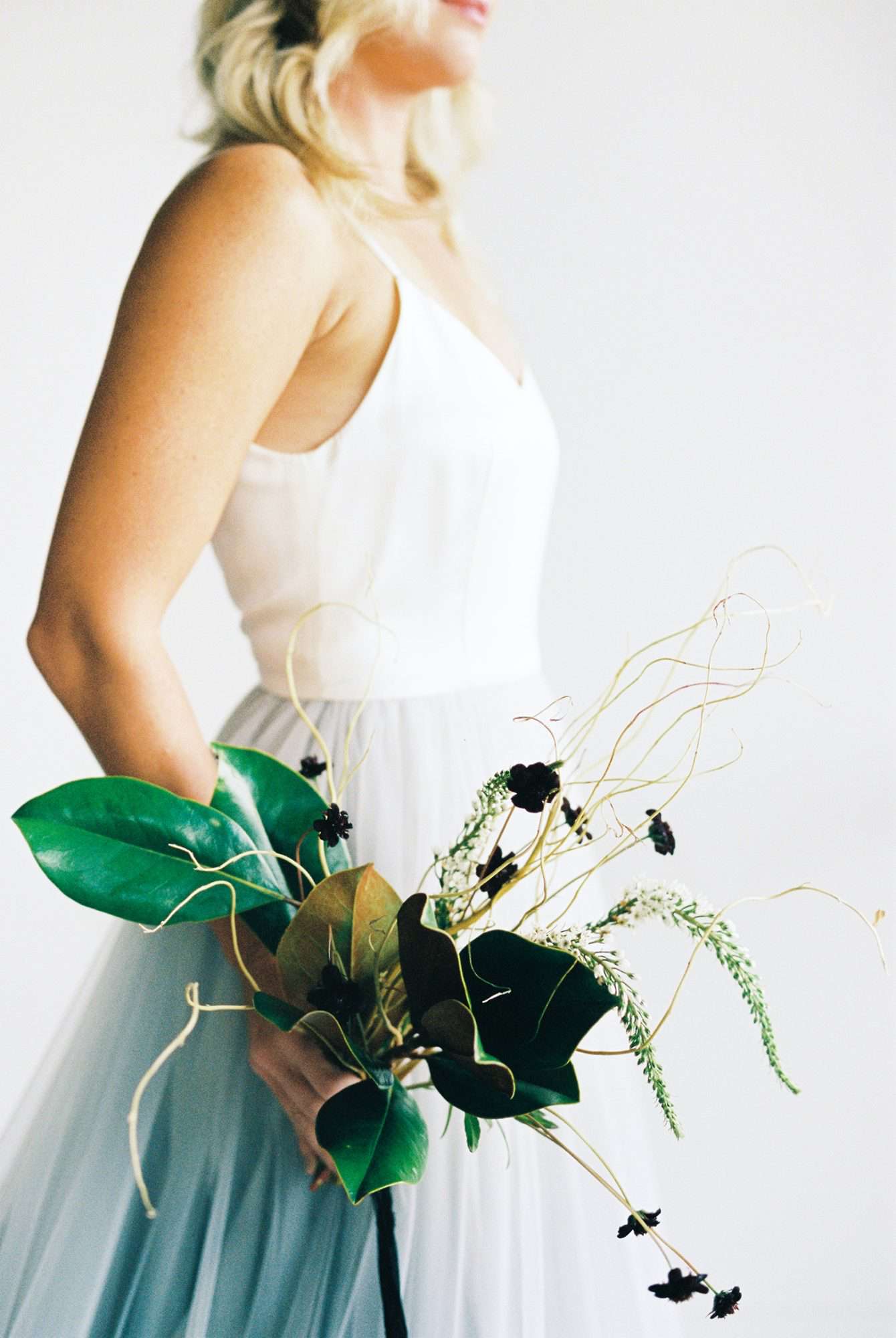 Modern Wedding Flowers - bridal bouquet with greenery, magnolia leaves and astilbe