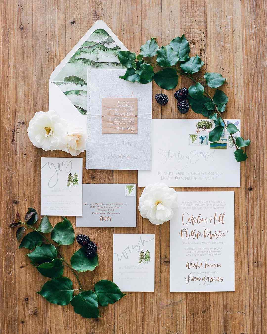 rustic wedding invitations with greenery and creative lettering