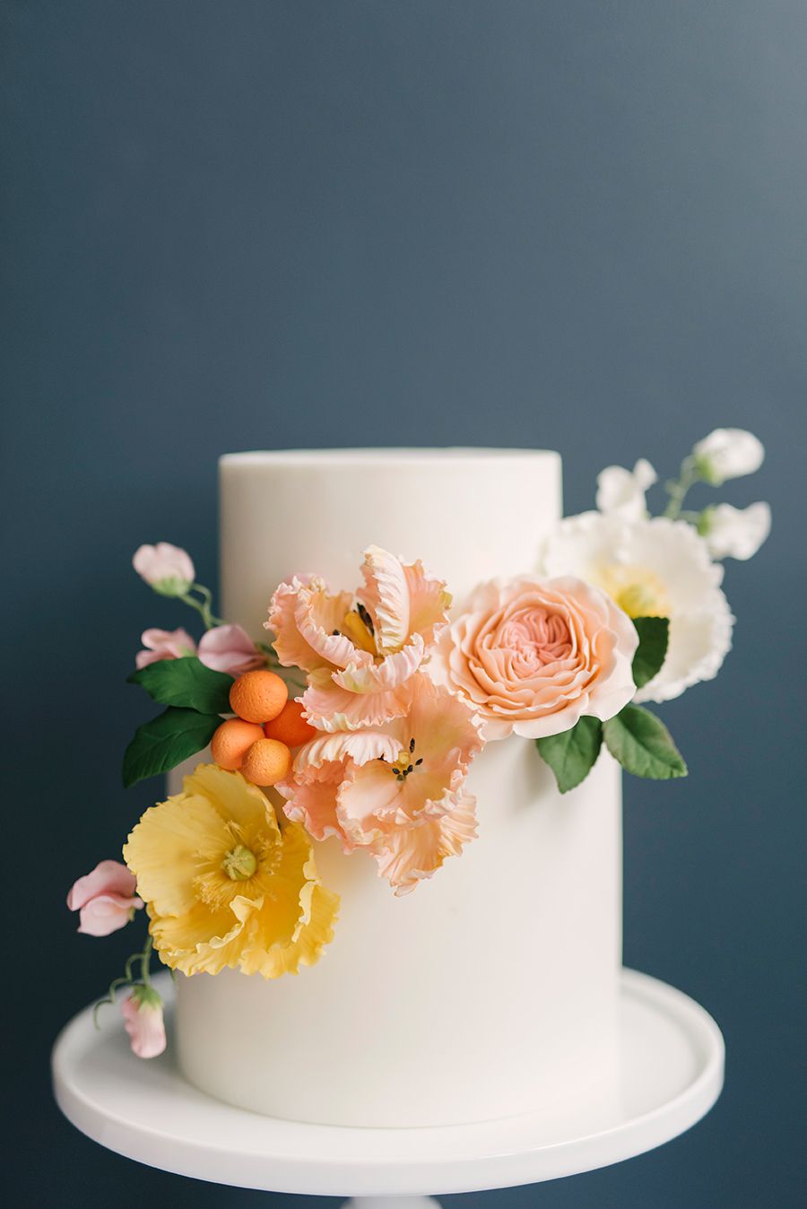 white fondant wedding cake with flowers