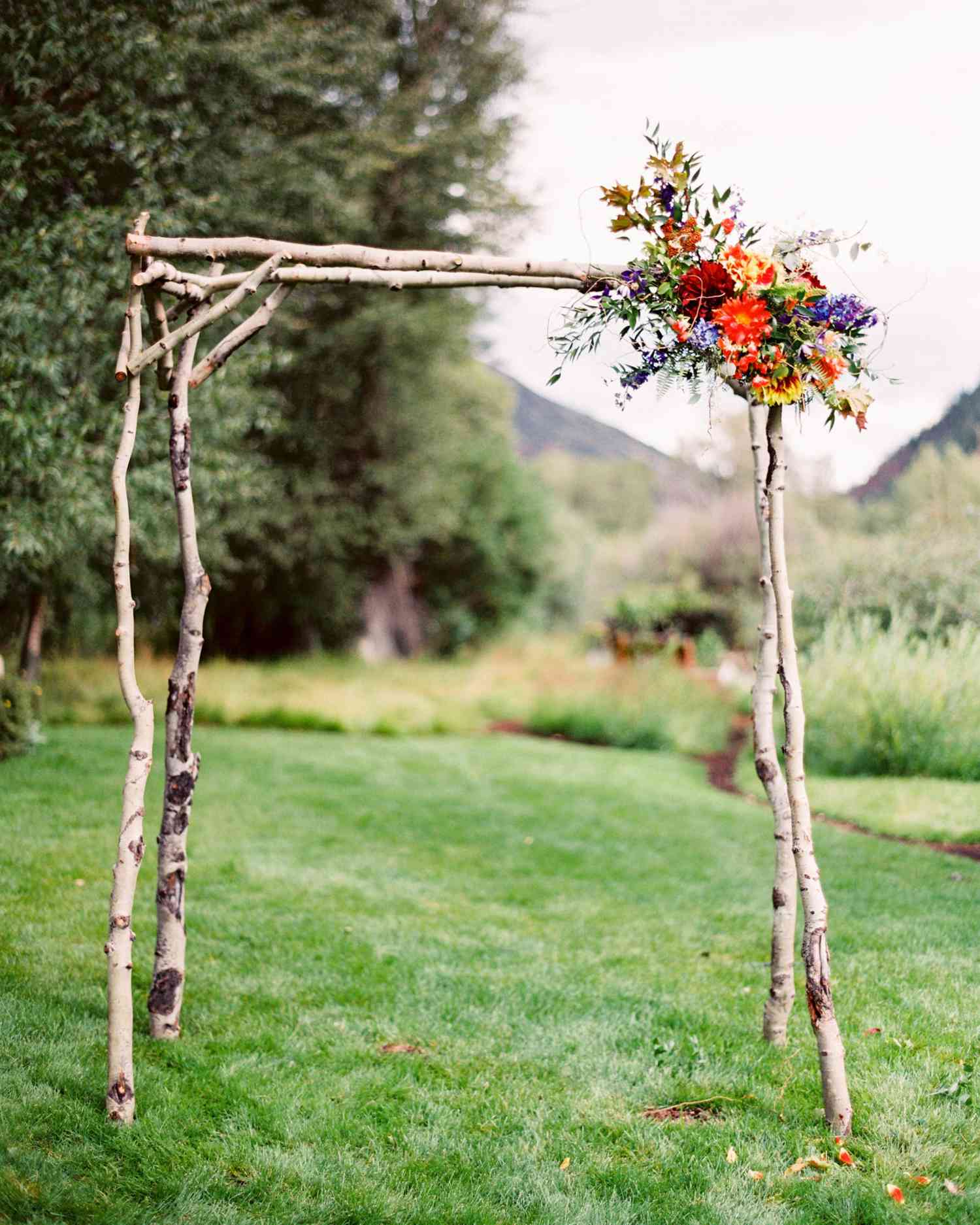 Unkempt Willow Branch Wedding Arch with Pink and Orange Flowers