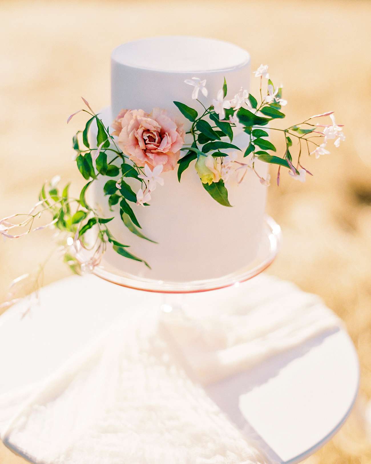 all-white two-tier floral accent cake