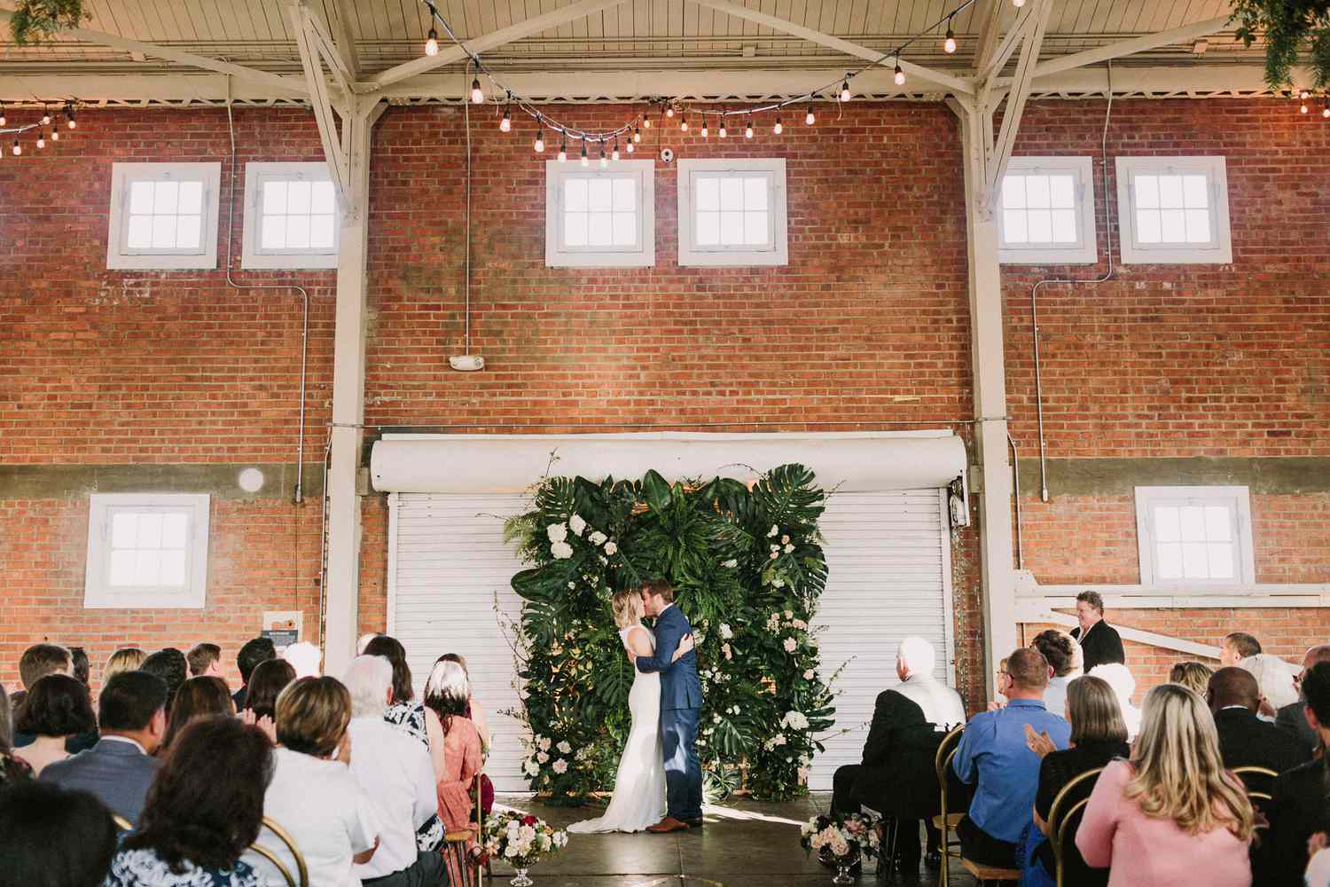 tropical greenery wedding ceremony backdrop pink white blooms