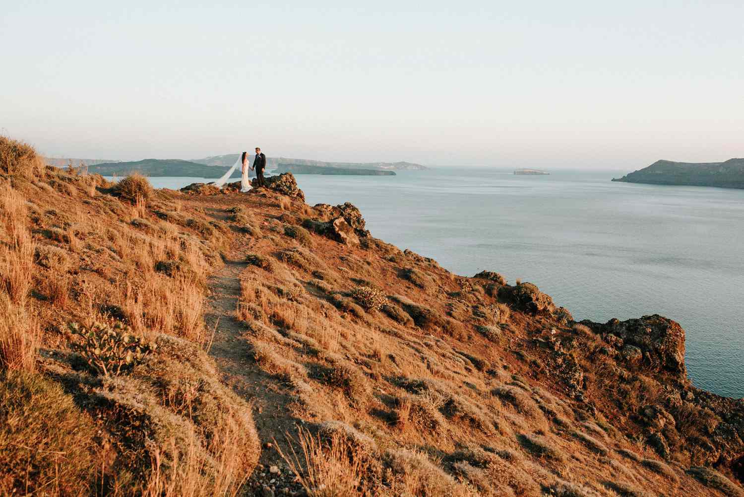 couple on hillside in santorini
