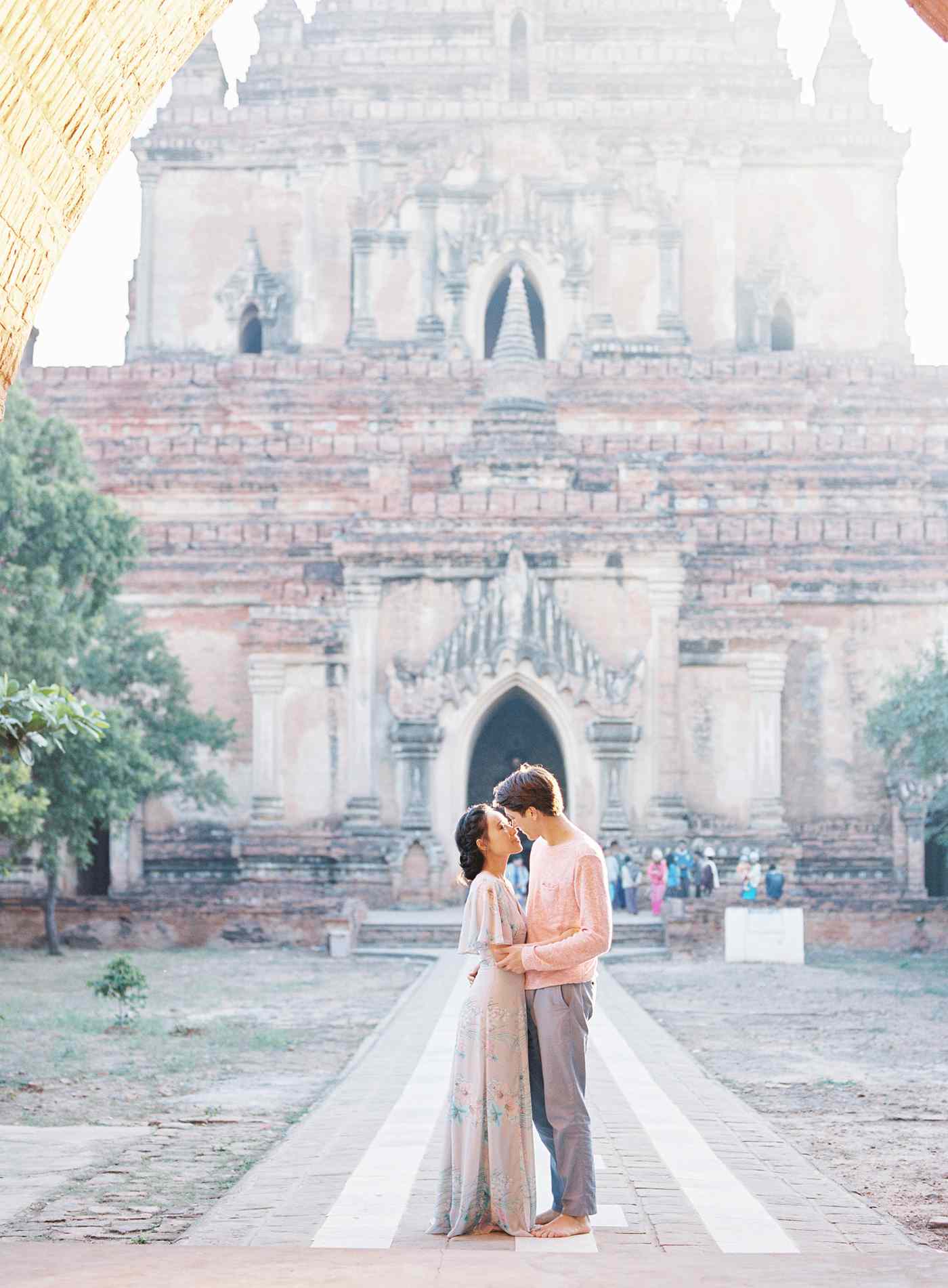 couple standing in front of temple