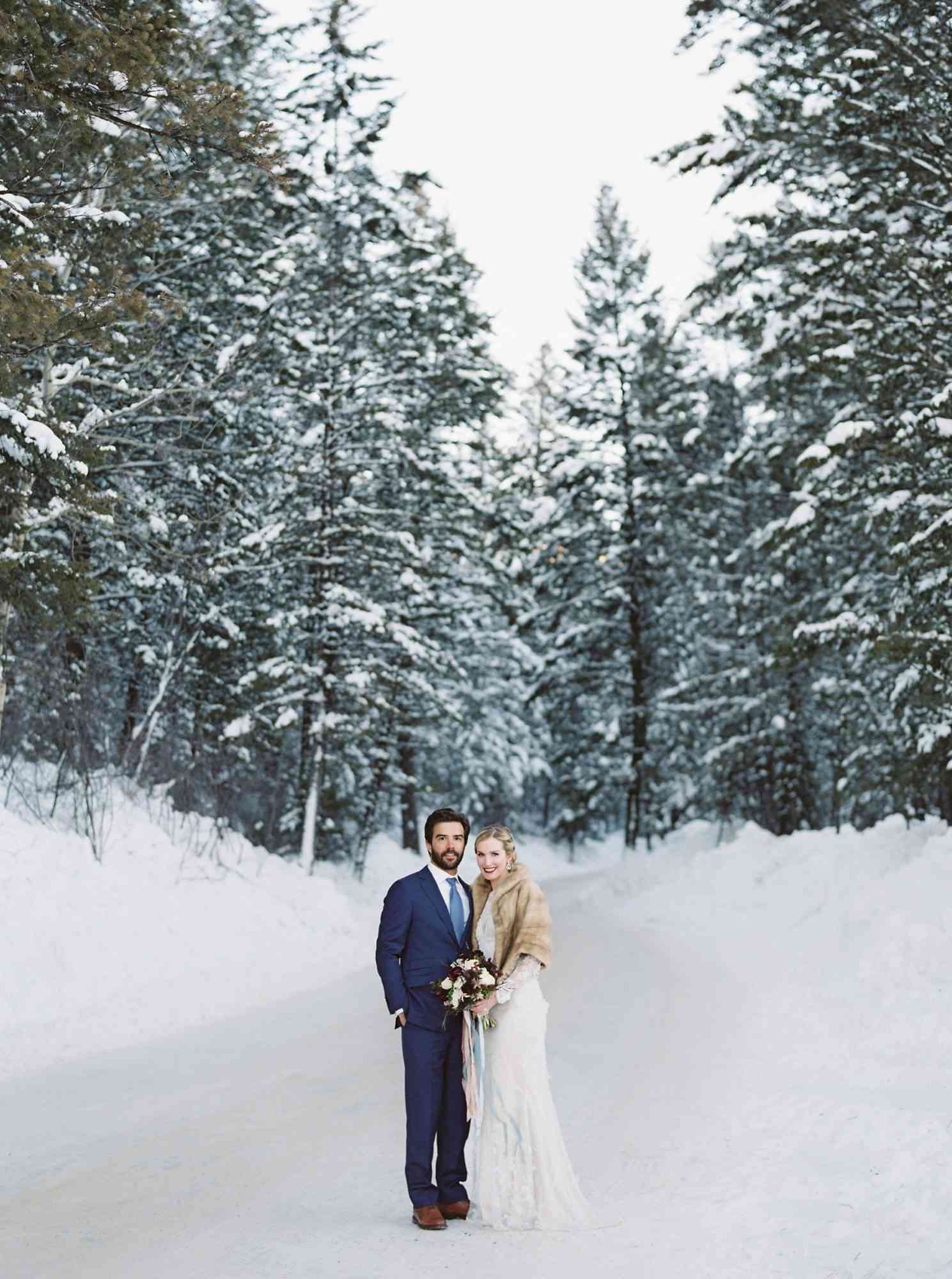 Bride and Groom in front of Evergreens