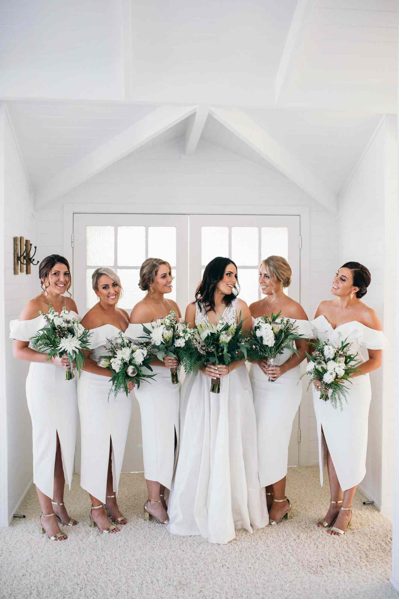 chic bridesmaids split front white gown with gold heels