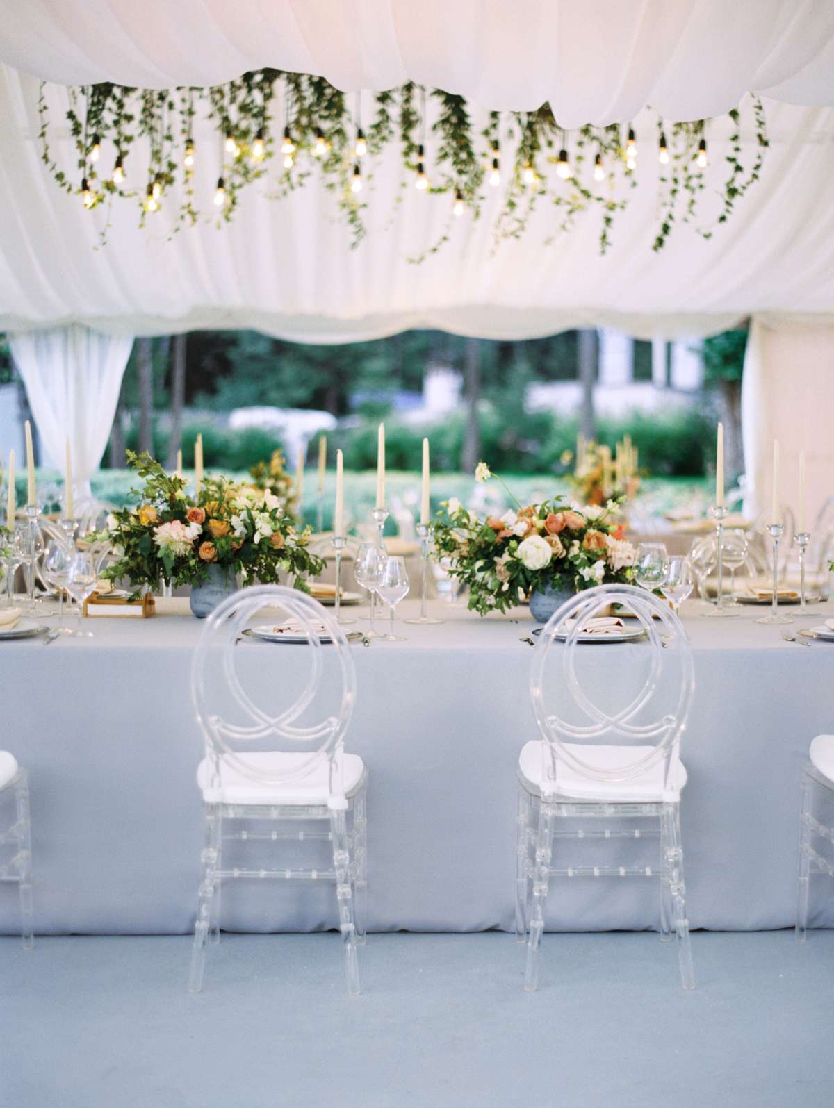 lucite chairs with an infinity back set up at reception table