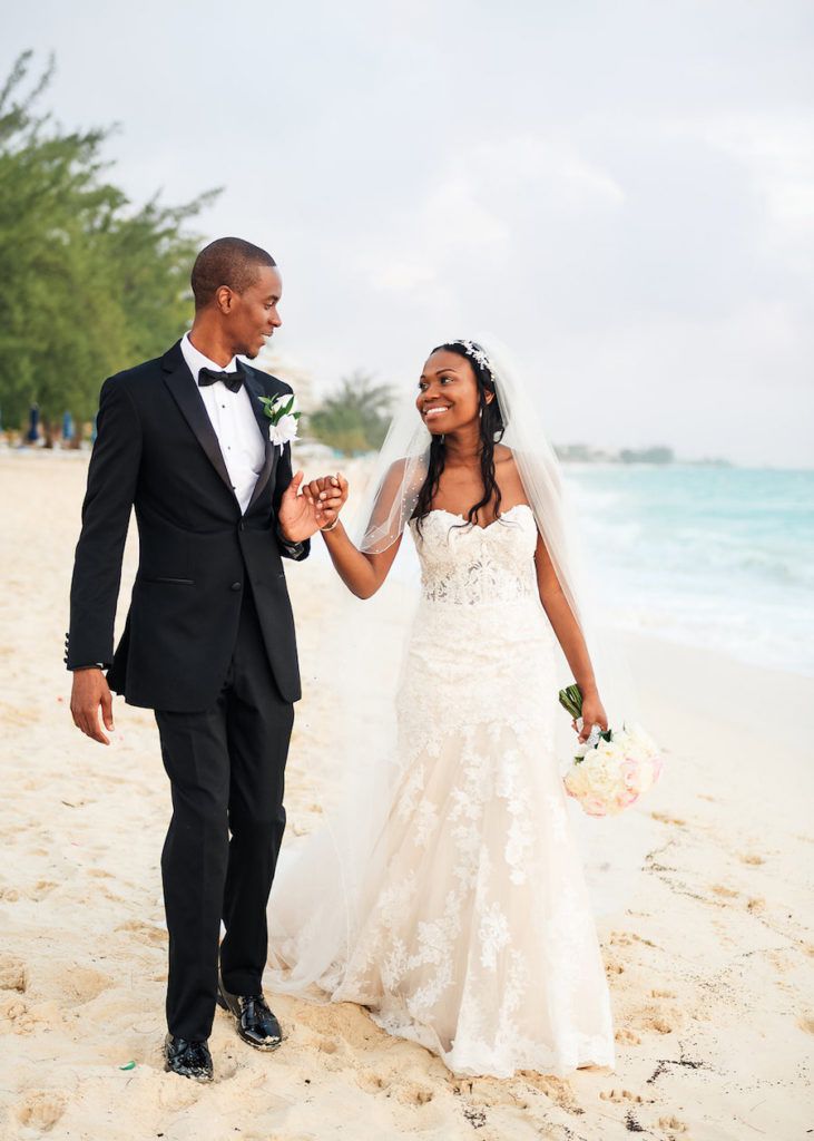 beach wedding dresses couple walking on beach