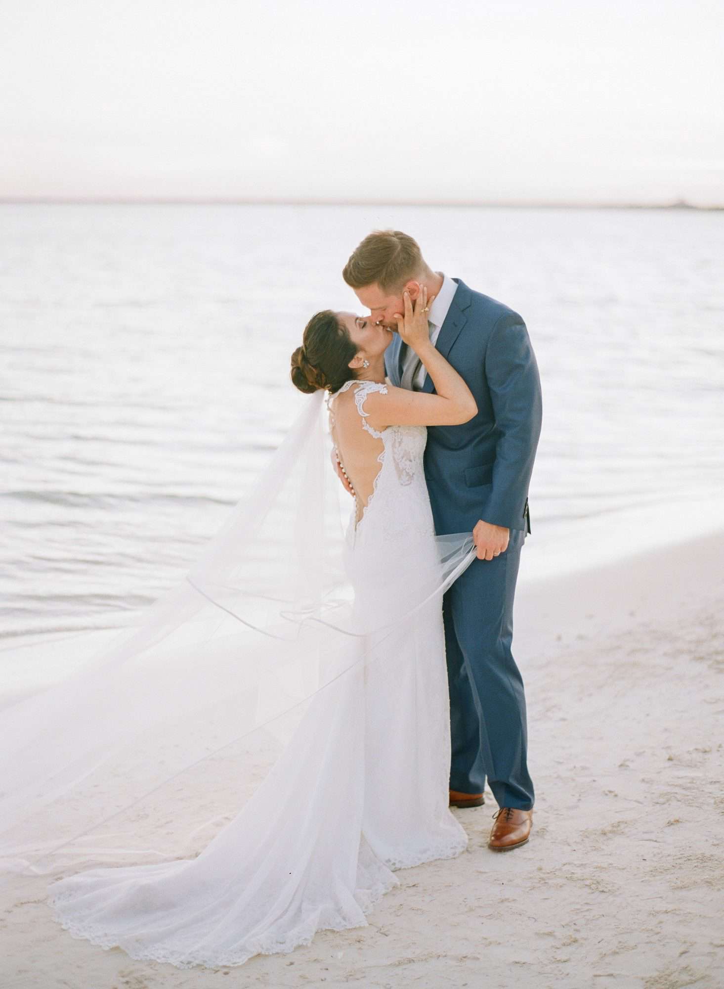 vicky james mexico wedding bride groom beach kiss