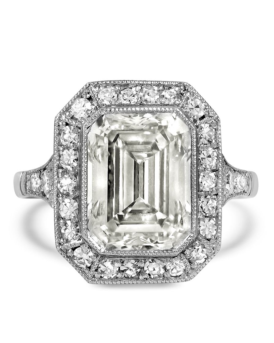 emerald cut diamond ring surrounded by single cut diamond accents