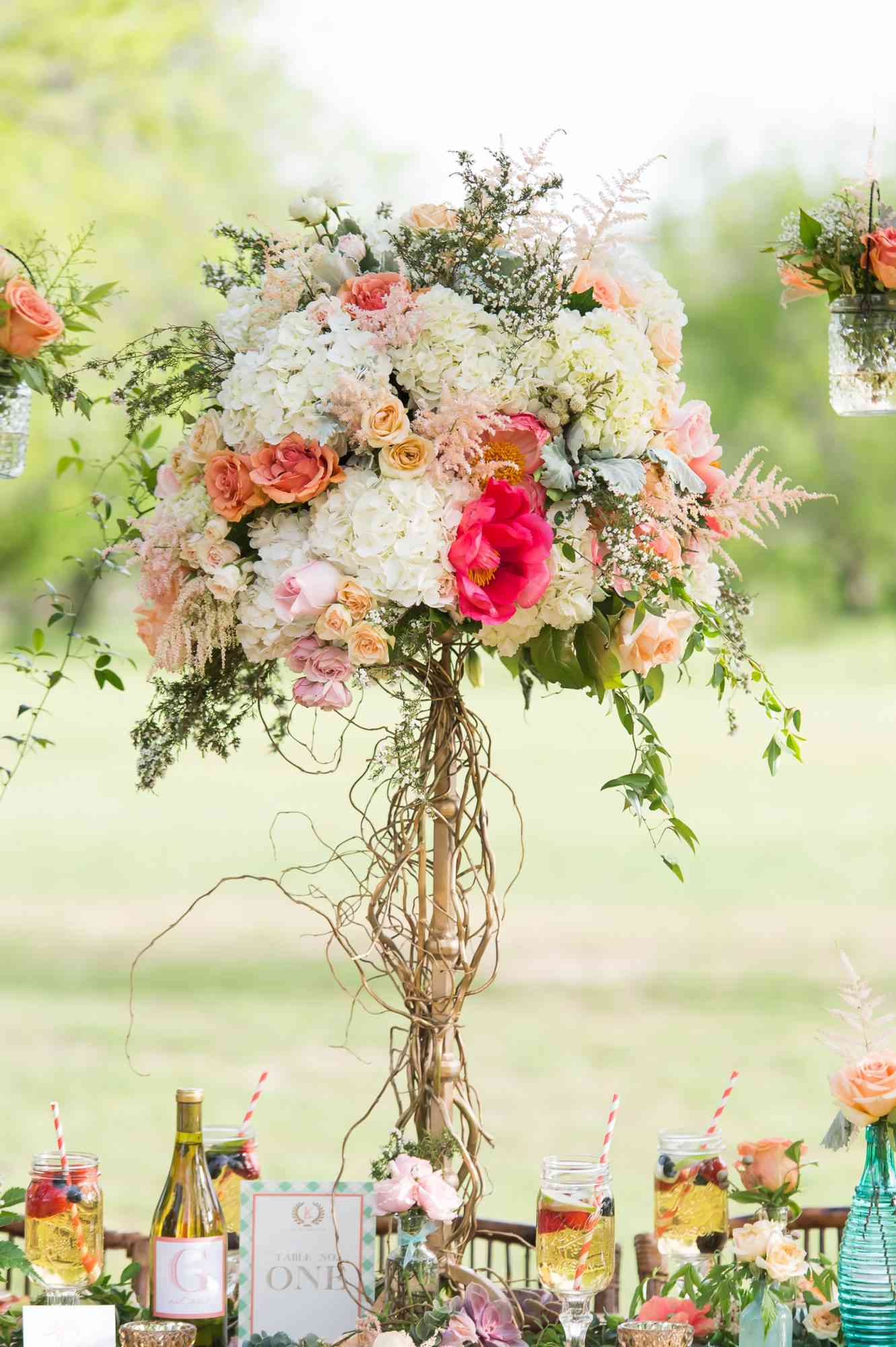 tall centerpiece with hydrangeas roses and peonies