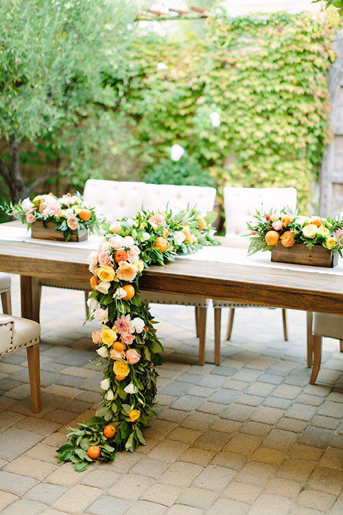 head table with citrus decorations