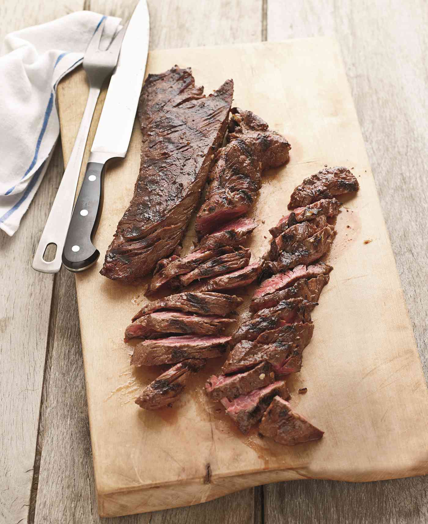 pat lafrieda balsamic marinated hanger steak on a wood cutting board