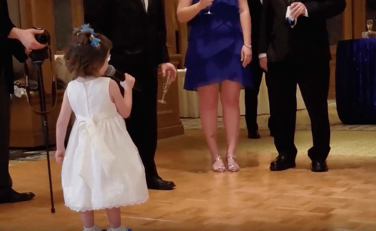 little girl giving wedding toast