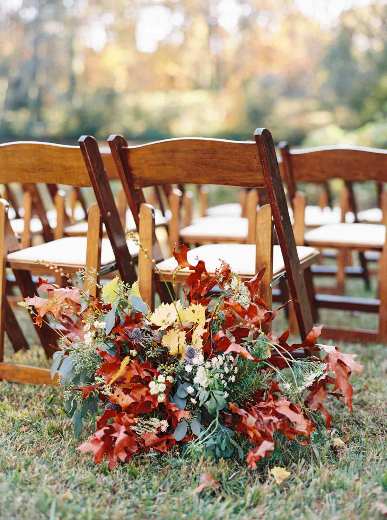 Colorful fall leaf arrangement behind chair