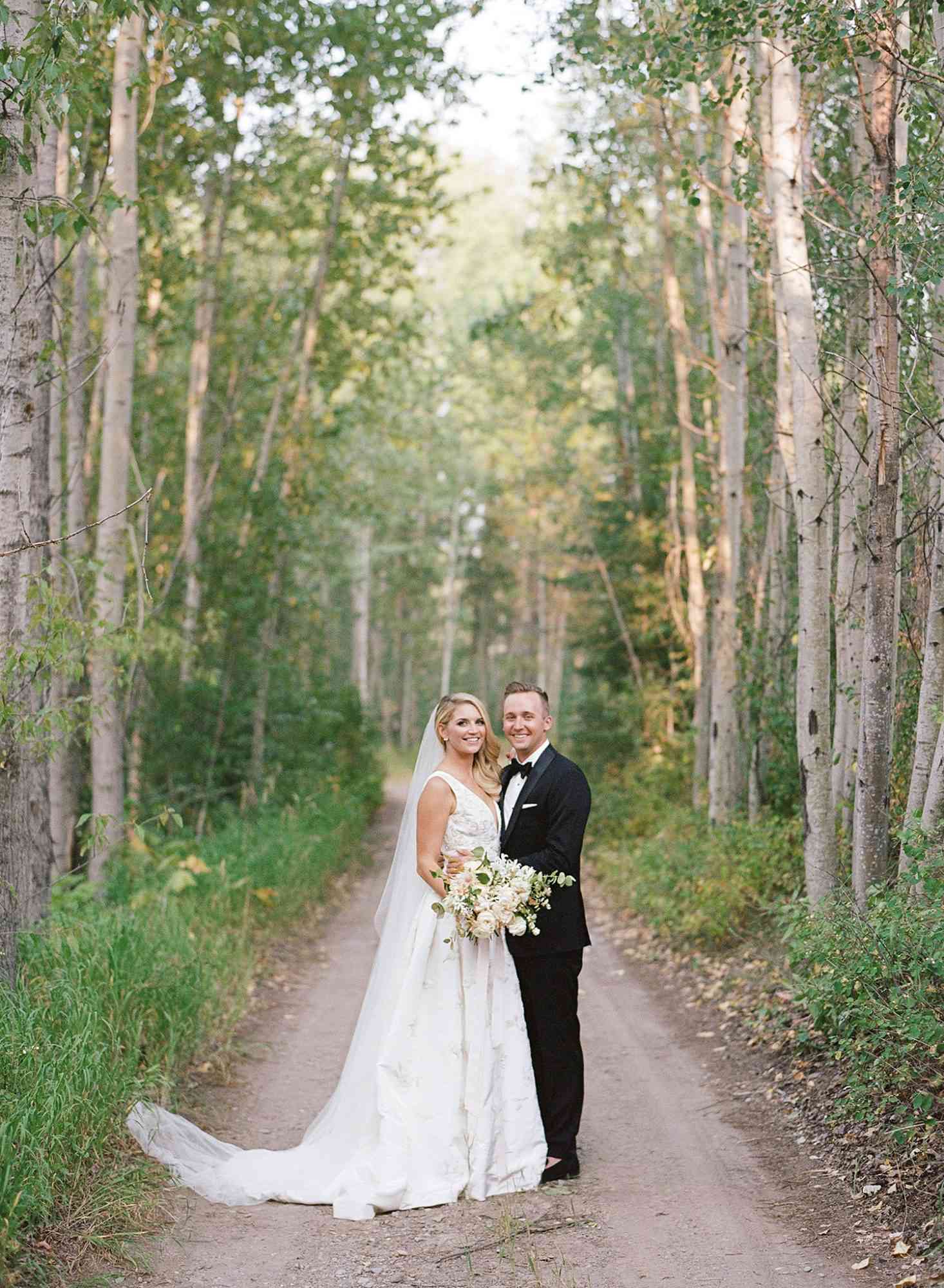 kaitlin jeremy wedding couple on tree-lined path